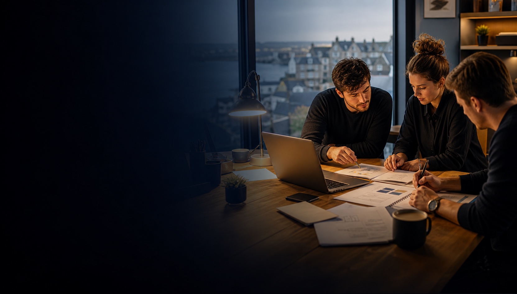 People planning a business launch around a laptop