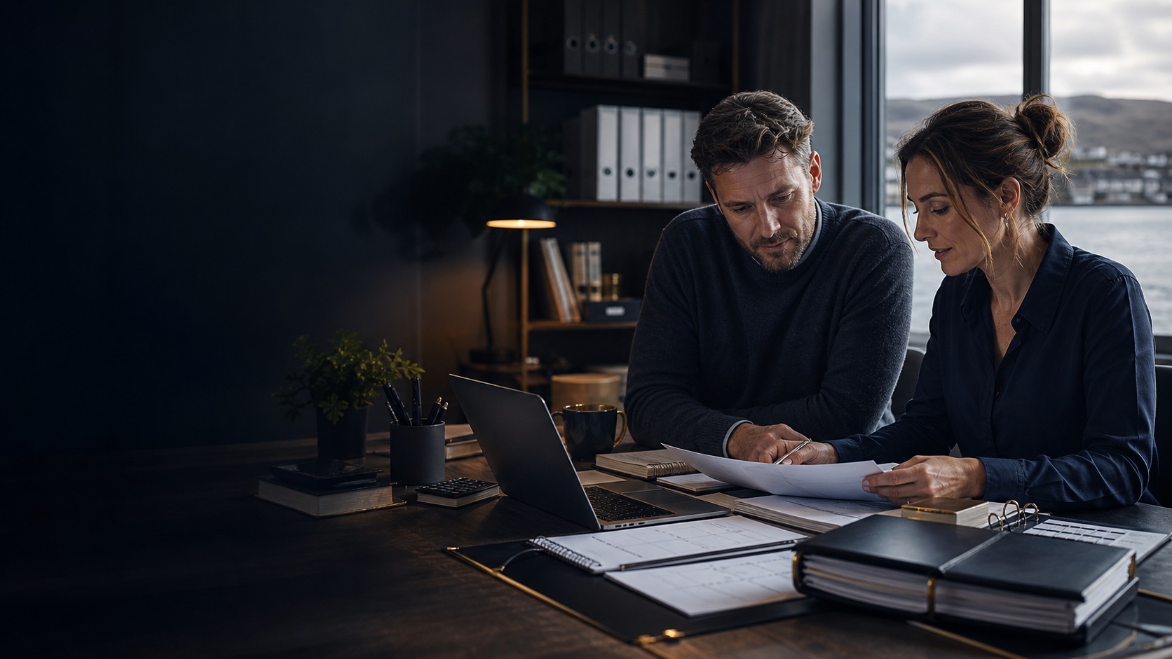 Business owner and operations support professional reviewing admin paperwork